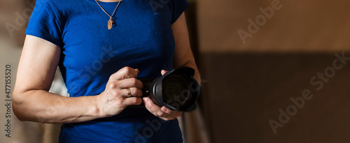 Banner Woman photographer is holding camera. concept of photography training, master class, photography school.