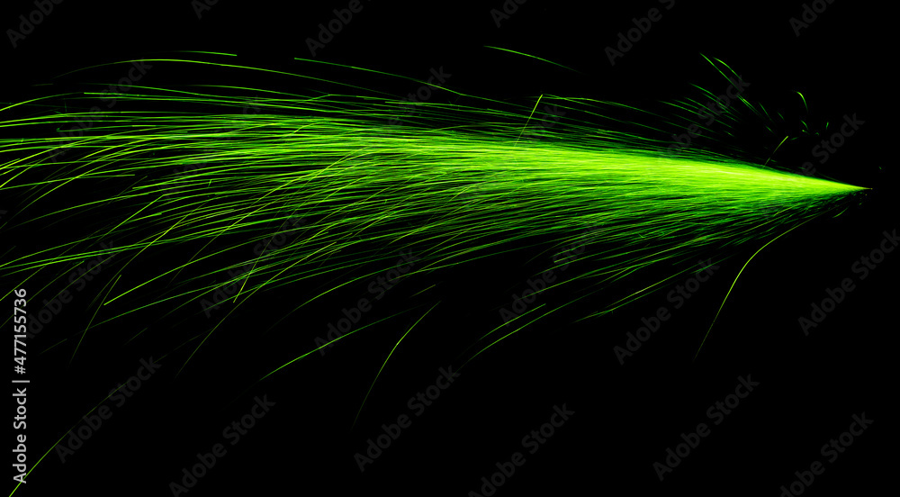 green fast-flying sparks from angle grinders on black background green fast-flying sparks from angle grinders on black background