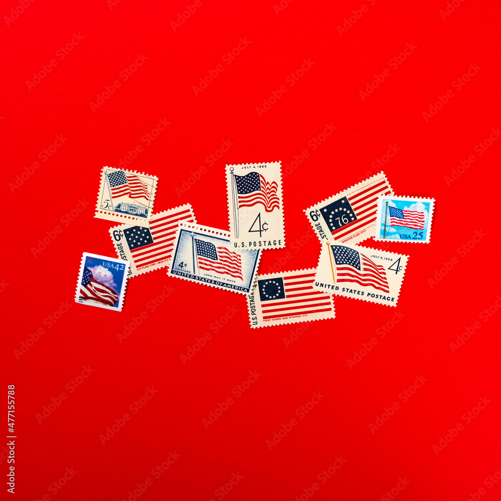 American flag postage stamps against red background Stock Photo | Adobe