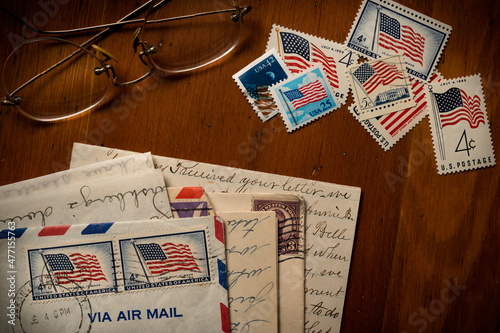 Letters with American flag postage stamps on table photo