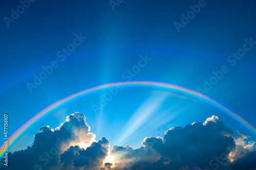 Double rainbow and clouds on sky at sunset