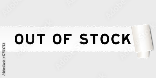 Ripped gray paper background that have word out of stock under torn part