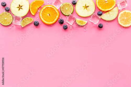 Slices citrus fruits and berries with with ice for making cocktail or juice