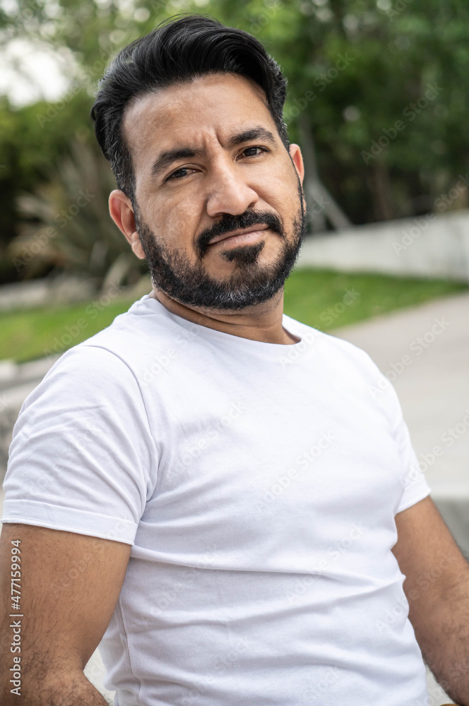 Portrait of Latin man with beard in a park Portrait of Latin man with beard in a park