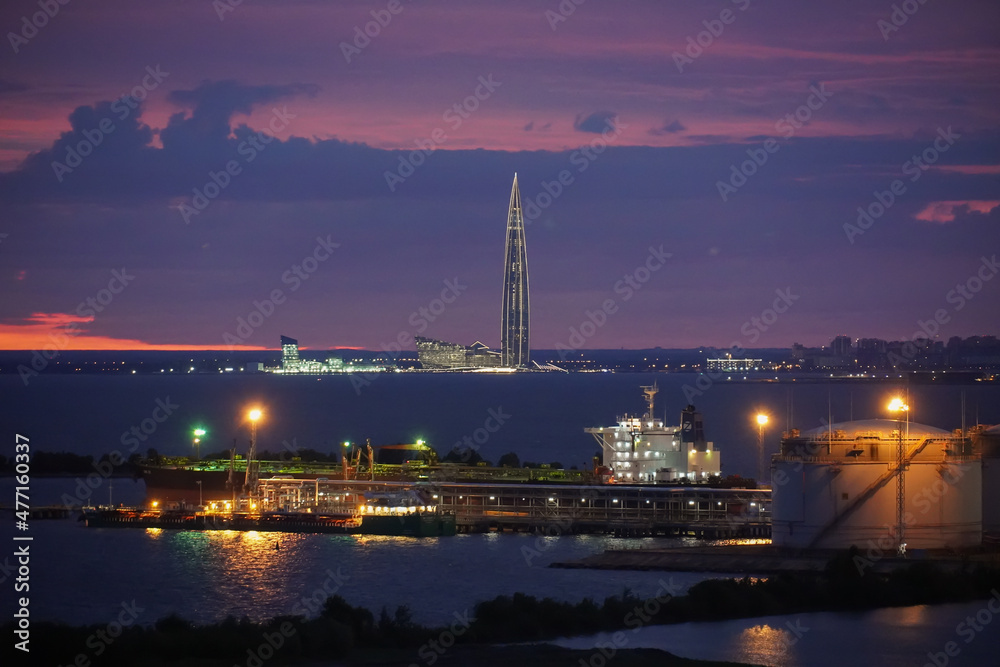 Night landscape. Oil tanker in the port of St. Petersburg Russia. The skyscraper lakhta center in the background. Beautiful summer sky. High quality photo