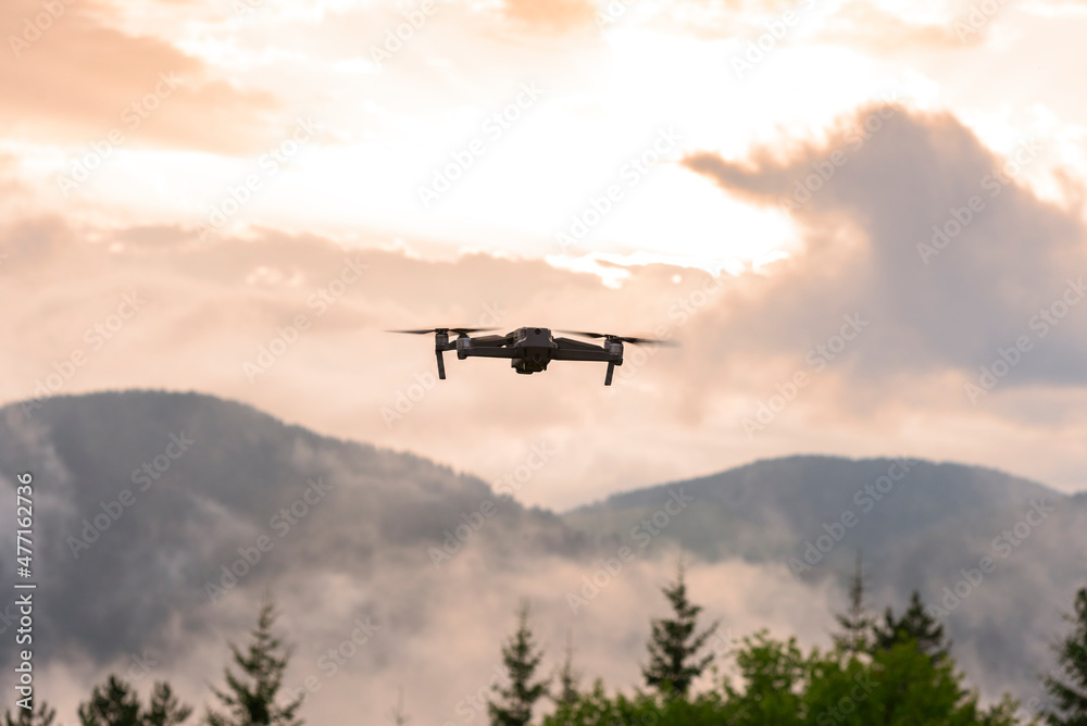 Drone with camera flying over mountain fields. Drone with camera flying over mountain fields.