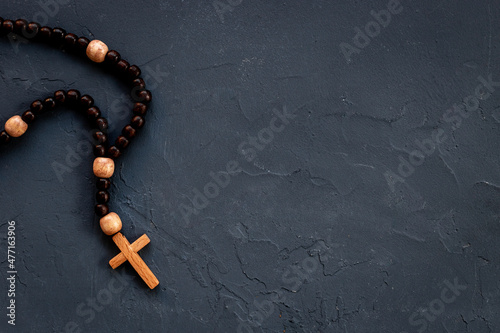 Close up of christian rosary beads with cross. Faith and prayer concept
