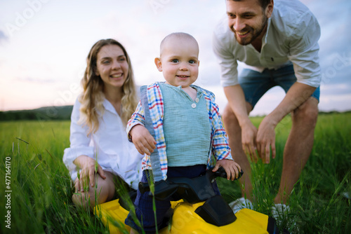 Parents with baby son (12-17 months) in agricultural field photo