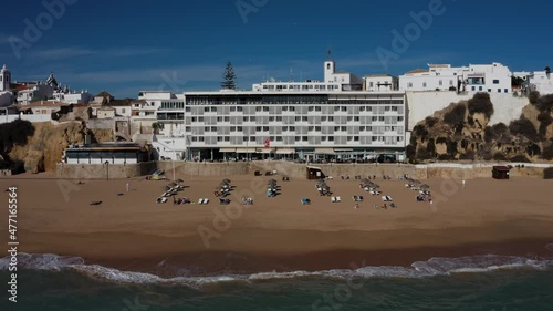 Albufeira cinematic drone aerial view. Drone flight over beautiful coastline, beach and old town. Sunny weather at the Atlantic ocean.  