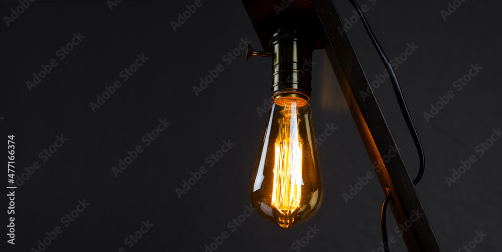 Bulb. Edison's light bulb. Desk lamp. Against a dark background. Black Bulb. Edison's light bulb. Desk lamp. Against a dark background. Black