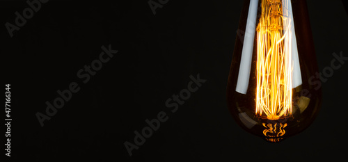 Bulb. Edison's light bulb. Desk lamp. Against a dark background. Black