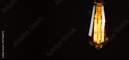 Bulb. Edison's light bulb. Desk lamp. Against a dark background. Black