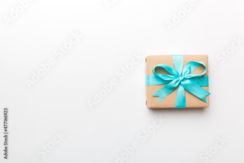 Holiday present box over colored background, top view. Copy space for design © sosiukin