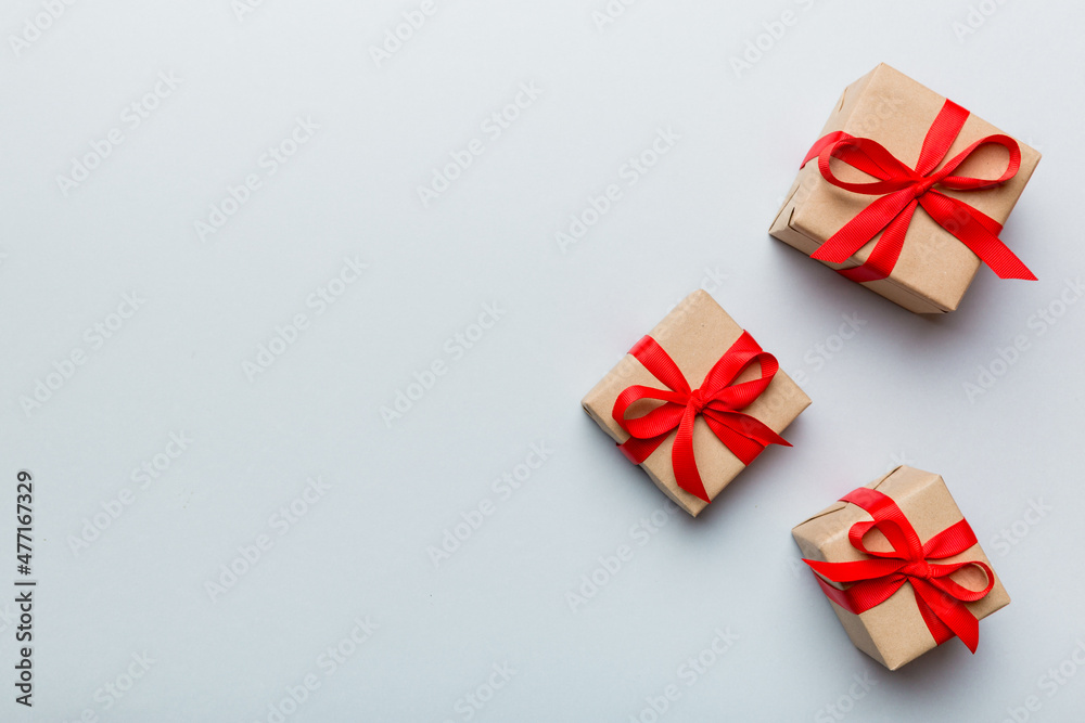 Valentine day composition: red gift box with bow and heart. Christmas present. View from above. Space for text. Holday greeting card Valentine day composition: red gift box with bow and heart. Christmas present. View from above. Space for text. Holday greeting card