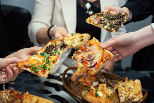Team people eating pizza in office