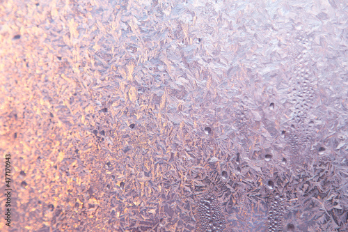 Winter frost on the window glass, ice purple pattern