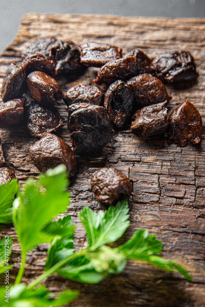 sun-dried olives smoked pitted olive fruit healthy meal food snack on the table copy space food background rustic top view keto or paleo diet veggie vegan or vegetarian food sun-dried olives smoked pitted olive fruit healthy meal food snack on the table copy space food background rustic top view keto or paleo diet veggie vegan or vegetarian food
