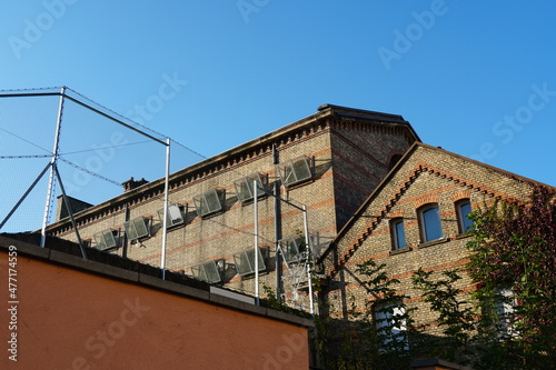 Obraz na płótnie Former penitentiary or prison building surrounded by high walls and security net