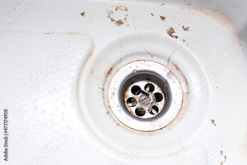 A sink drain hole with limescale or lime scale and rust on it  dirty rusty bathroom washbowl