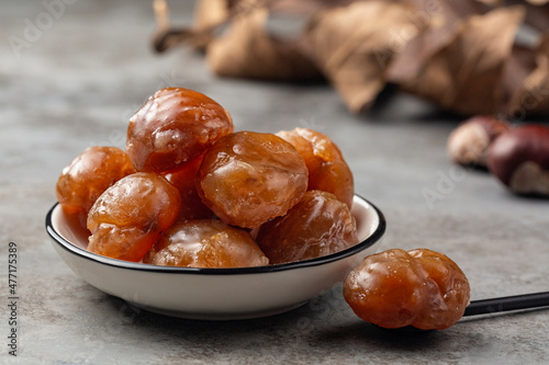 Marron glacé,  confection, originating in northern Italy and southern France consisting of a chestnut candied in sugar syrup and glazed. photo