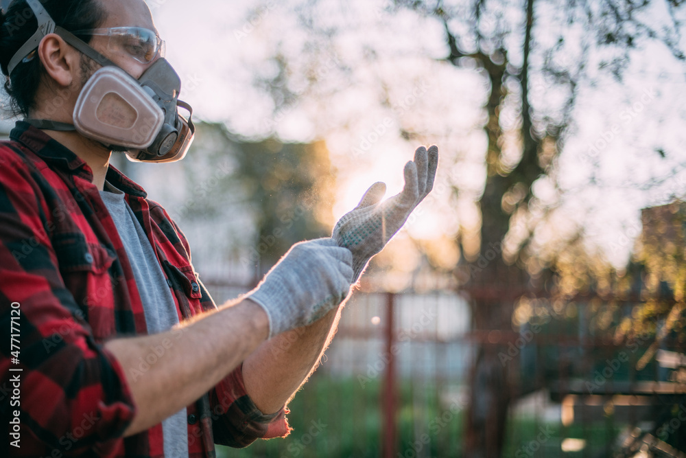 Fototapeta premium A man in goggles, gloves and a respirator. Means of protection.