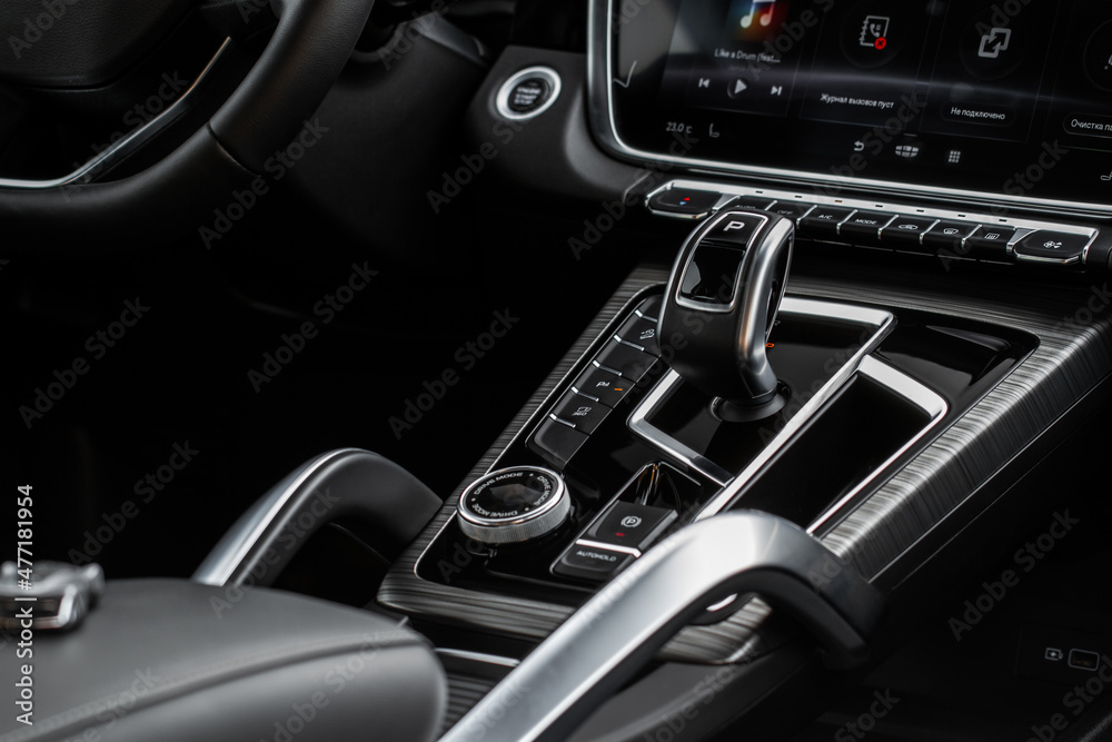 Car interior console close up view. Gear stick with multimedia console.