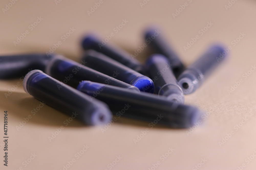 several blue ink cartridges on a textured background several blue ink cartridges on a textured background