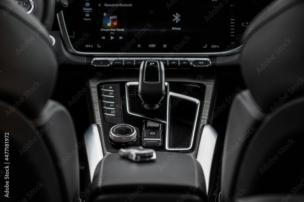 Car interior console close up view. Gear stick with multimedia console. Front view.