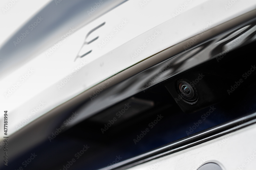 Close up view of rear view parking assist video camera on the car. Modern rear view cameara on modern car trunk. Parking assistant system. Close up view of rear view parking assist video camera on the car. Modern rear view cameara on modern car trunk. Parking assistant system.