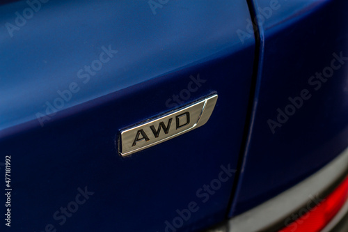 AWD emblem on modern black SUV car detail close up view. All Wheel Drive chrome badge. © Roman