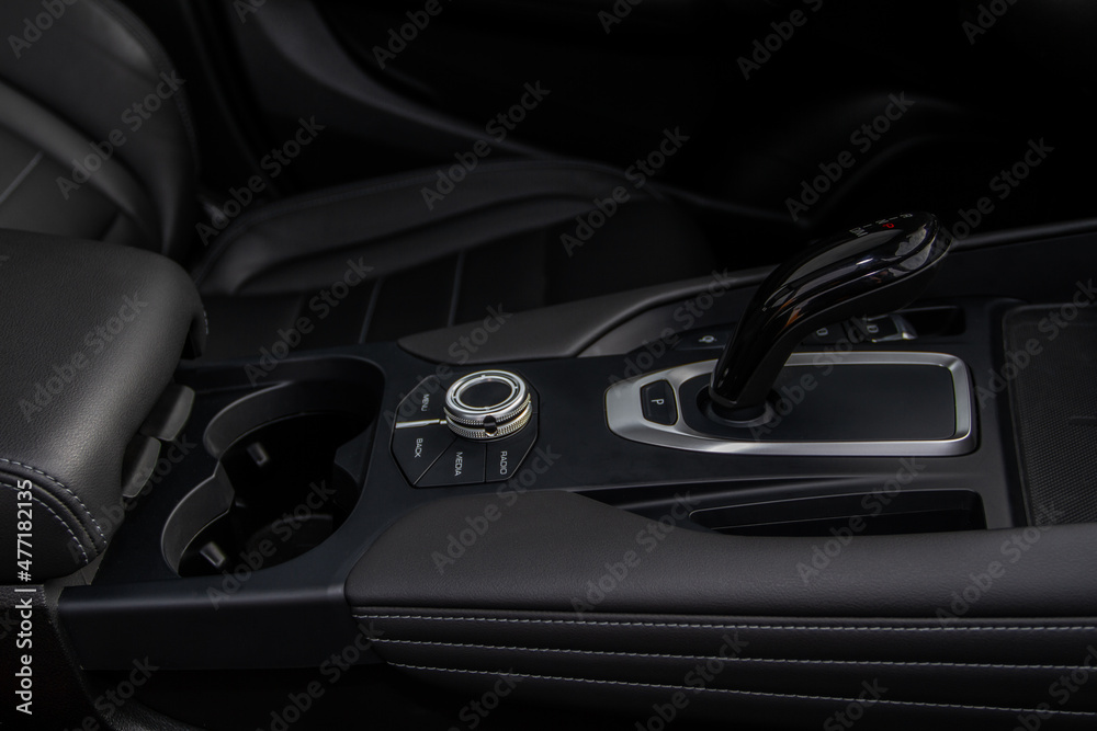Modern automatic gearbox. Close up of the gearbox transmission handle. Automatic gear stick. Side view. Modern automatic gearbox. Close up of the gearbox transmission handle. Automatic gear stick. Side view.