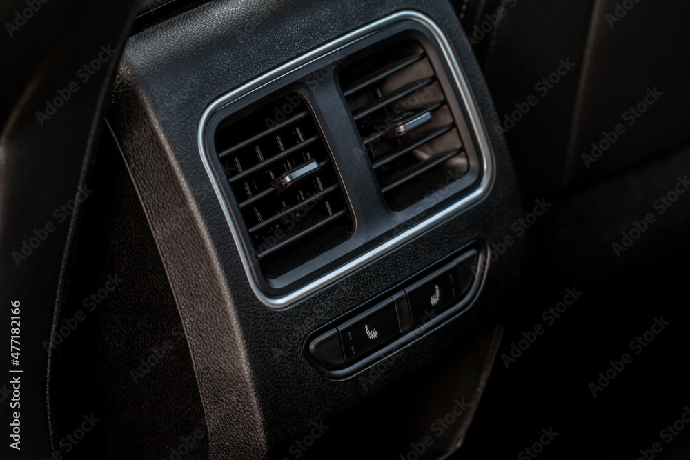 Car air conditioning close up view. The air conditioner flow inside the car. Detail interior of car. Air ducts. Car air conditioning close up view. The air conditioner flow inside the car. Detail interior of car. Air ducts.