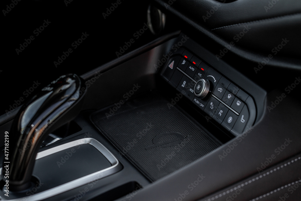 Wireless mobile charger in the modern car. Portable wireless car charger for smartphone.