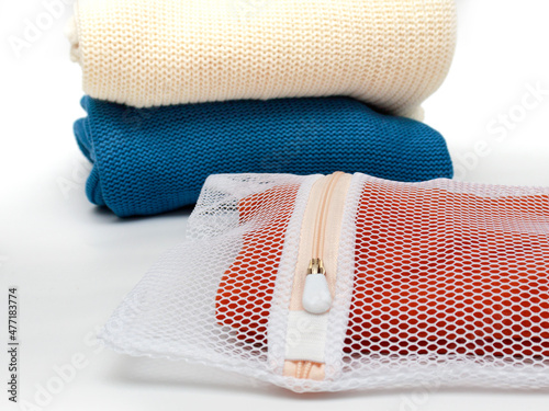 Knitwear in a bag for delicate washing of fabrics. The concept of gentle washing of clothes, fabrics