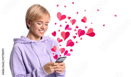 Beautiful young woman with phone sending love message on white background