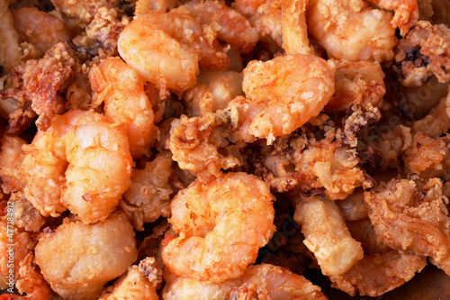 Delicious close-up photo of a fried seafood with shrimp, squid and cuttlefish. 