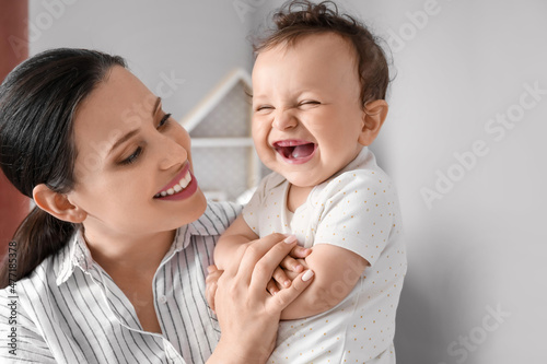 Young mother holding her li...