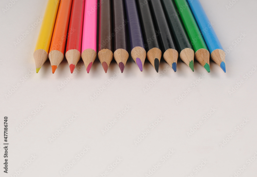 Set of colored pencils on a light background