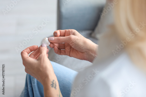Mature woman with nicotine patch at home, closeup. Smoking cessation