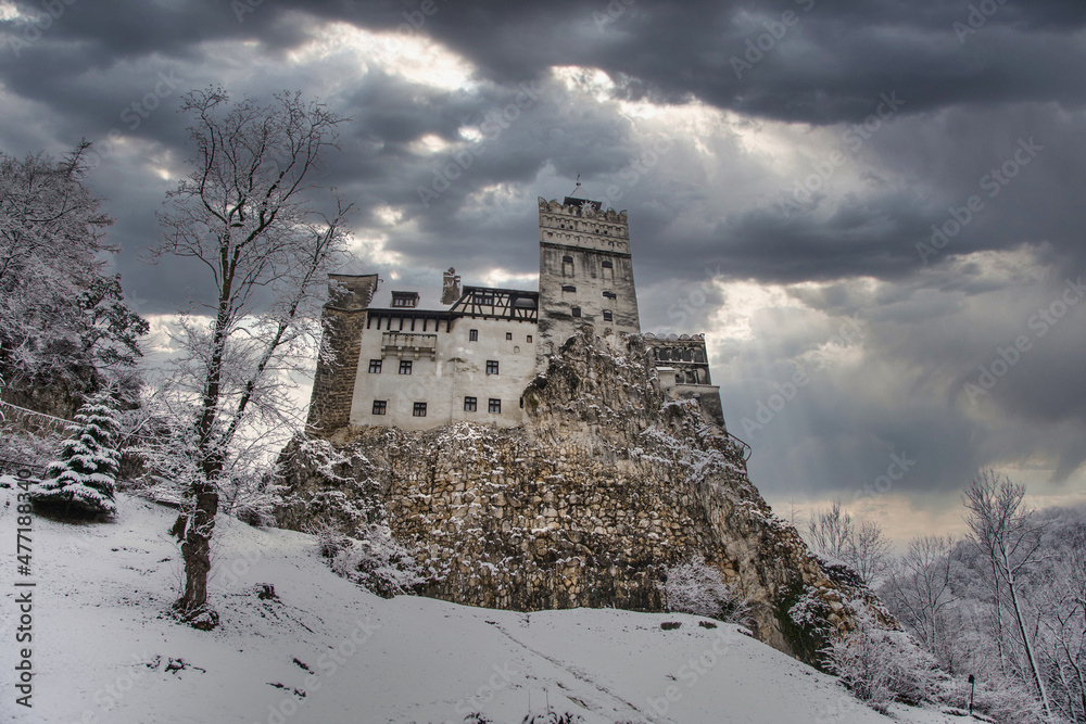 Stock photo of Bran Castle, located in Transylvania, Romania. Dracula's Bran. Dramatic Image Of A Medieval Castle With A Snowy Background. Travels and tourism.	