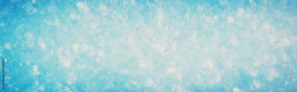 Snowy background with closeup panoramic view of the crystal snowflakes Snowy background with closeup panoramic view of the crystal snowflakes