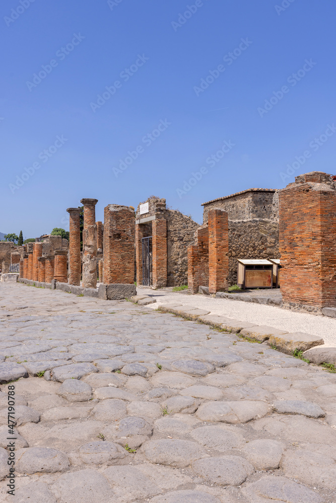 Ruins of an ancient city destroyed by the eruption of the volcano Vesuvius near Naples, Pompeii, Italy. View of one of the city streets
