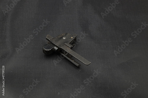 The pistol trigger mechanism on black background © Сергей Луговский