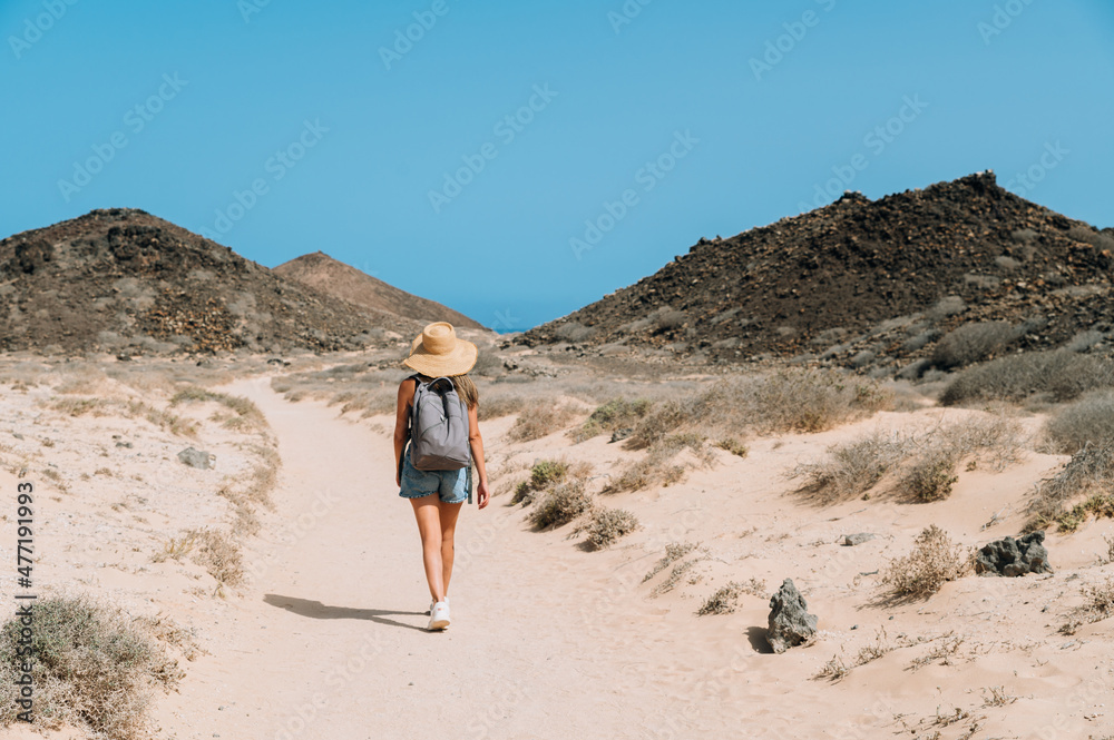 Traveler walking along mountain road