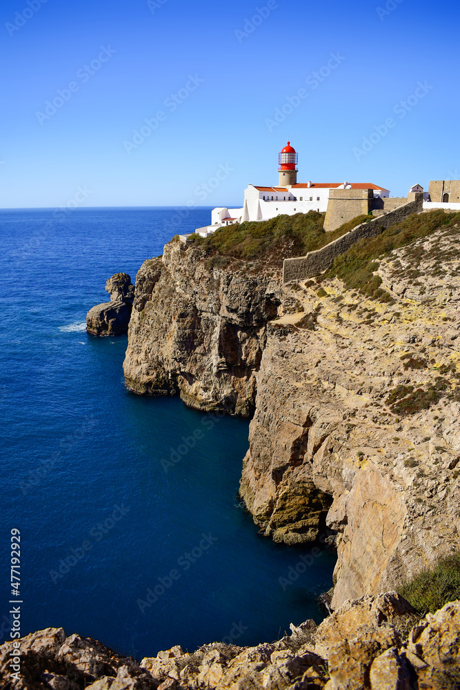 Lighthouse on Cabo de Sao Vicente cliffs, rocky Algarve coastline