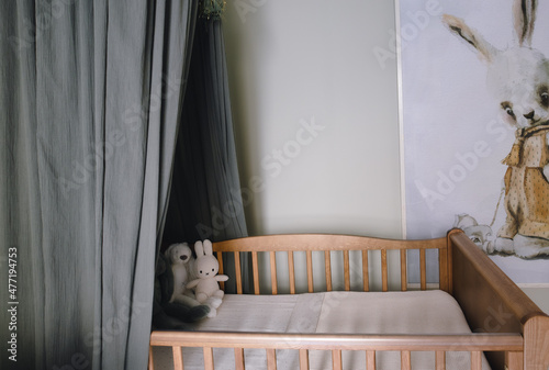 Stylish scandinavian newborn baby room with toys Modern interior with green background walls