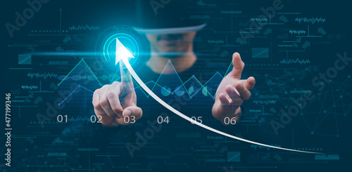 Man wearing VR glasses virtual touch arrow of Investment finance chart stock market business and financial growth graph,Business strategy development and growing growth plan, growth graph Technology.