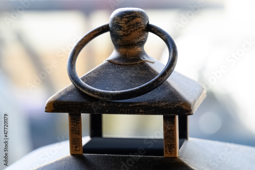 closeup view of the top of a dusty metallic decorative lantern
