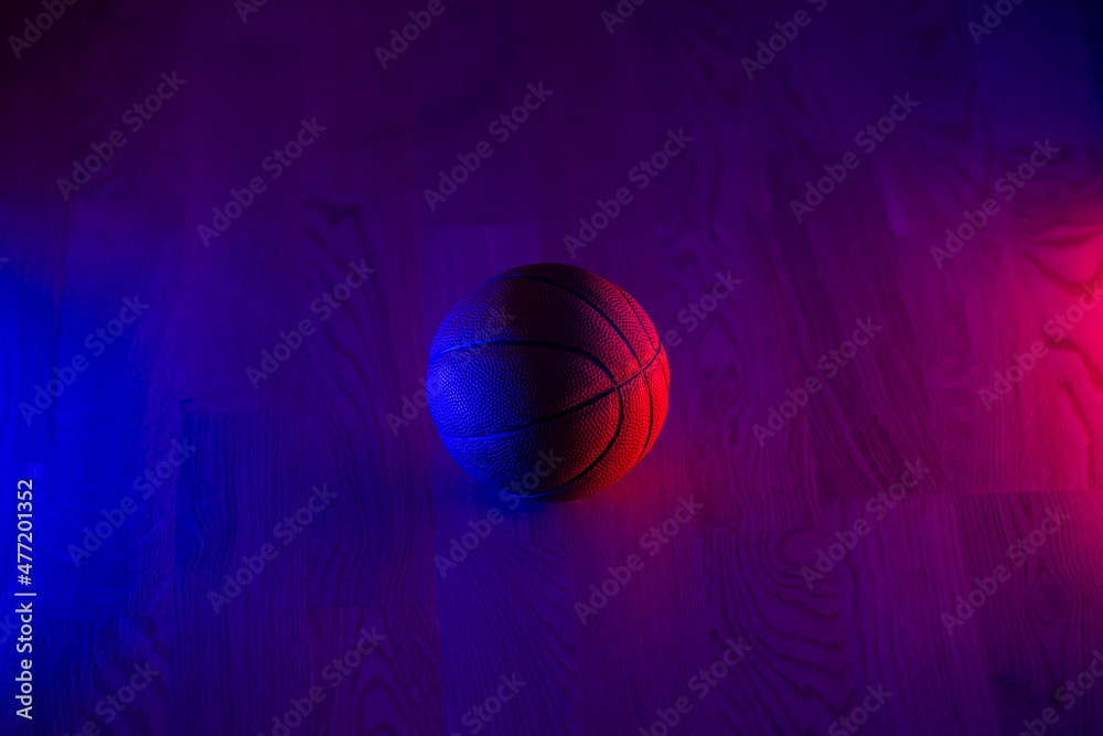 Basketball ball isolated on dark background. Blue neon banner. Horizontal sport theme poster, greeting cards, headers, website and app Basketball ball isolated on dark background. Blue neon banner. Horizontal sport theme poster, greeting cards, headers, website and app
