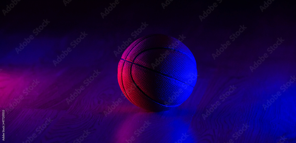 Basketball ball isolated on dark background. Blue neon banner. Horizontal sport theme poster, greeting cards, headers, website and app